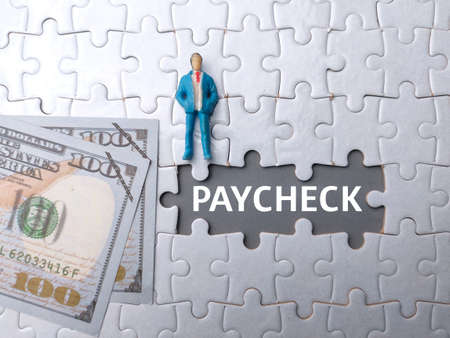 One gift wrapped in dark black paper on a white background.の写真素材