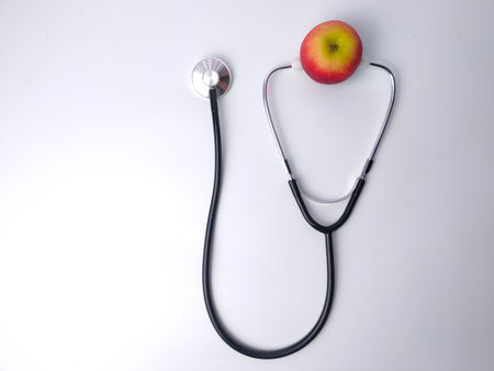 Stethoscope and red apple isolated on a white background. Health care and medical concept idea.の写真素材