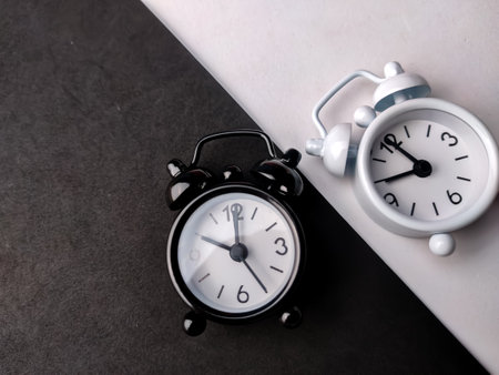 Top view red and black alarm clock on a red and black background with copy space.の写真素材
