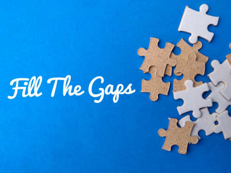 Wooden house and coins with text ZAKAT on a blue background.の写真素材