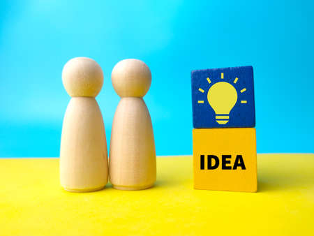 Toys word and notebook with text FAQS on a yellow background.の写真素材