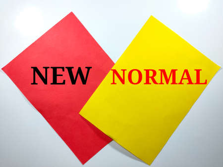 Word NEW NORMAL on color paper with white background.Pandemic concept.の写真素材