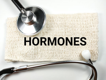 Medical concept.Word HORMONES with stethoscope on white background.