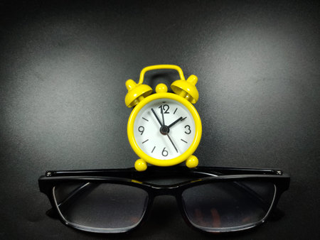 Selective focus of calculator and magnifying glass on black background with Copy space.