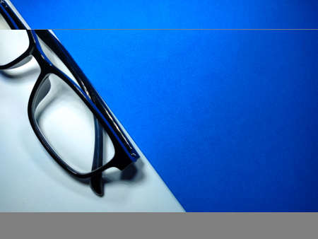 Selective focus of clock and dollar banknote on red and yellow background with copy space.の写真素材