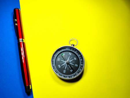 Selective focus of clock and dollar banknote on red and yellow background with copy space.の写真素材