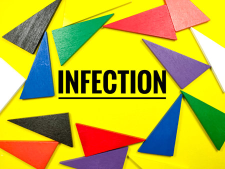 Medical concept.Colorful pieces of wood on yellow background with text INFECTION