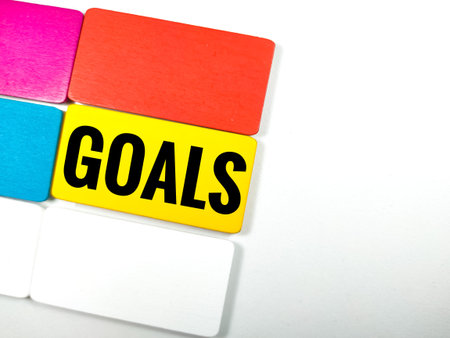 Business and finance concept. Text GOALS on colorful wooden board on white background.