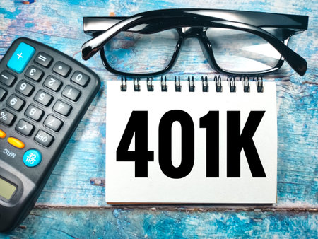 Business concept. Text 401k with calculator and glasses on wooden background.