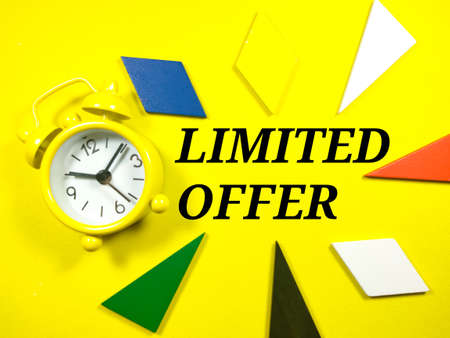 Text LIMITED OFFER with alarm clock on yellow background.の写真素材