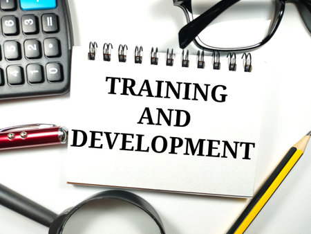 Business and finance concept.Text TRAINING AND DEVELOPMENT with magnifying...