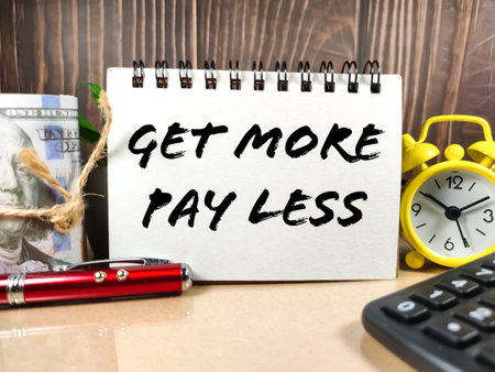Business concept.Text GET MORE PAY LESS with banknote,pen,calculator and clock on light table.
