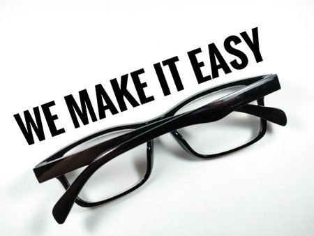Business concept.Text WE MAKE IT EASY with glasses on white background.