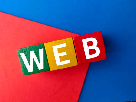 Top view wooden block with text WEB on colored background.の写真素材