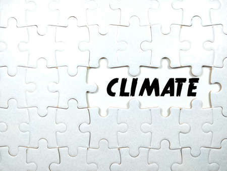 Selective focus.Text CLIMATE with jigsaw puzzle on white background.の写真素材