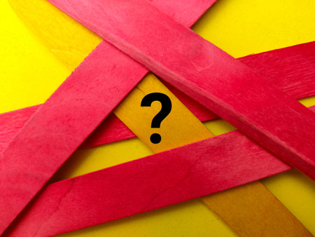 Top view colored ice cream stick with symbol question mark on yellow background.の写真素材