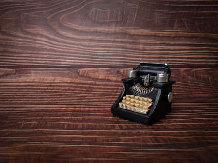 Vintage black typewriter on the wooden background, copy space for your textの写真素材