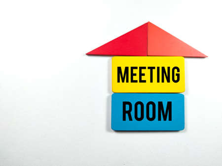 Colorful wooden board with text MEETING ROOM on white background.の写真素材