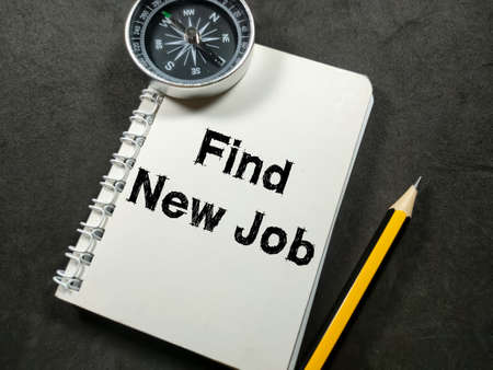 Business concept.Text Find New Job on notebook with pencil and compass on black background.の写真素材
