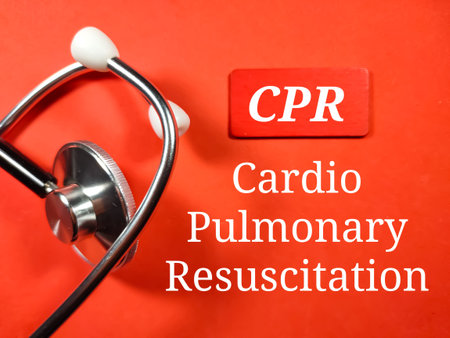 Medical concept.Text CPR (Cardio Pulmonary Resuscitation) with stethoscope on red background.