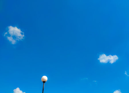 Street lights with a background of bright blue skies and white clouds.Copy and text space concept.の写真素材