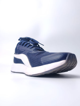 Malaysia, 25 March 2022: Puma blue shoes on a white background. Puma is the third largestÂ sportswearÂ manufacturer in the worldのeditorial素材
