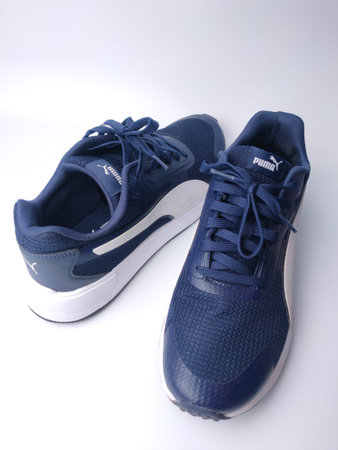 Malaysia, 25 March 2022: Puma blue shoes on a white background. Puma is the third largestÂ sportswearÂ manufacturer in the worldのeditorial素材