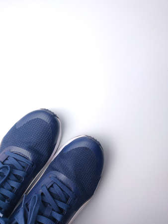 Malaysia, 25 March 2022: Puma blue shoes on a white background. Puma is the third largestÂ sportswearÂ manufacturer in the worldのeditorial素材