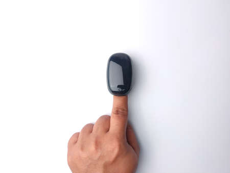 Malaysia,28 March 2022: Someone hand use oximeter on a white background.のeditorial素材