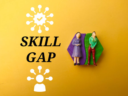 Miniature people and icon with text SKILL GAP on yellow background.