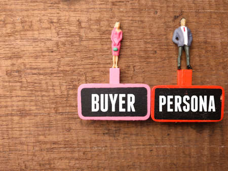 Wooden board and miniature people with text BUYER PERSONAL on a wooden background.の写真素材