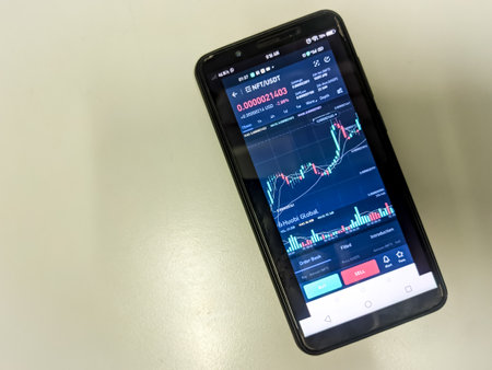 Malaysia, 14 April 2022: NFT graph in a smartphone screen on a table.のeditorial素材