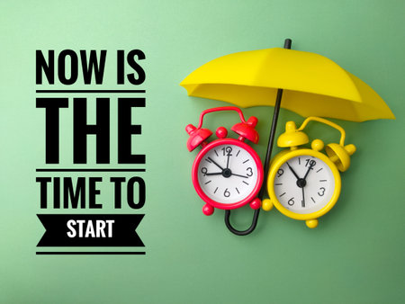 Umbrella and alarm clock with text NOW IS THE TIME TO START on green background.