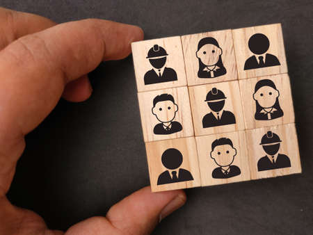 Wooden block with icons of a group of team workers. the concept of group relationshipsの写真素材