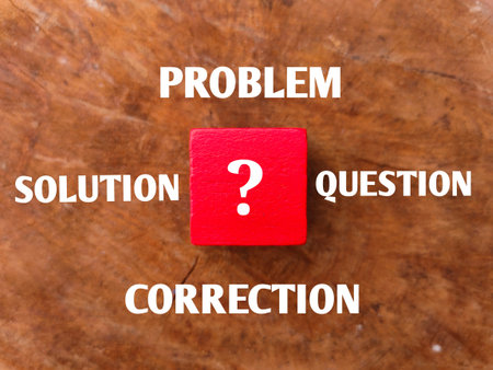 Wooden cube with question mark symbol and word PROBLEM SOLUTION QUESTION CORRECTION.