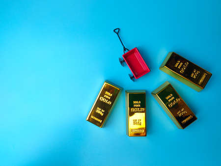 Miniature garden metal and gold bar on a blue backgroundの写真素材