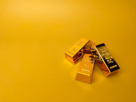 Gold bars and Financial concept and conceptual image on a yellow background with copy and text space.の写真素材
