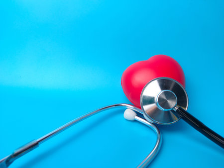 Stethoscope and red heart on a blue background. Healthcare and medical concept.