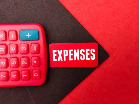 Top view calculator and colored board with the word EXPENSES.の写真素材