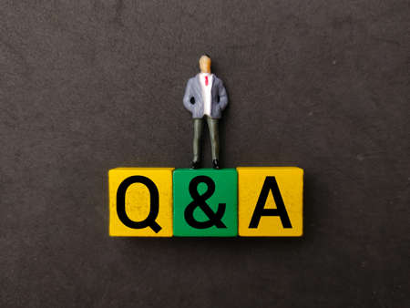 Miniature people and colored block with the word Q AND A.の写真素材
