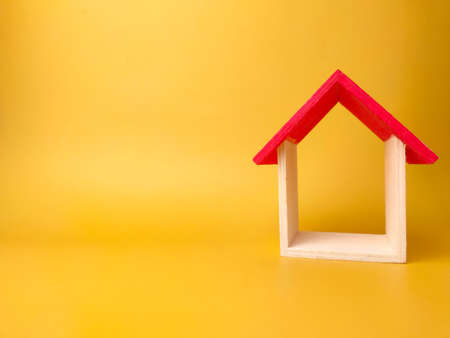 Toy house isolated on yellow background with copy spaceの写真素材