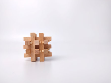 Wooden toy puzzle on a white background with copy space.
