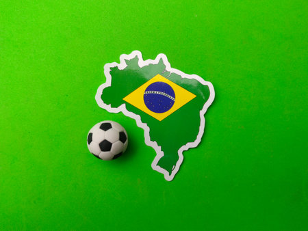 A ball and brazil flag sticker is on a green background.の写真素材