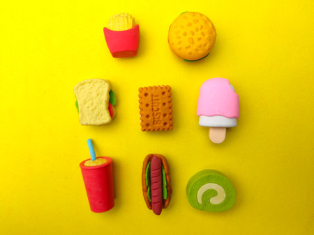 Various types of colourful food toys on a yellow background.の写真素材