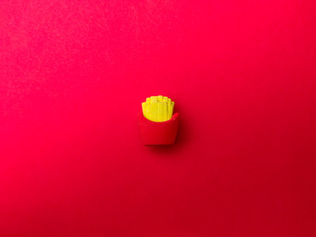 Top view of toy fried potatoes on a red background.の写真素材