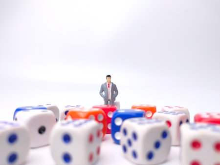 Colored dice and miniature businessman on a white background.Business concept.の写真素材