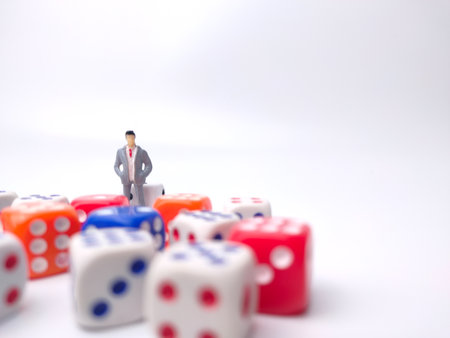Colored dice and miniature businessman on a white background.Business concept.の写真素材