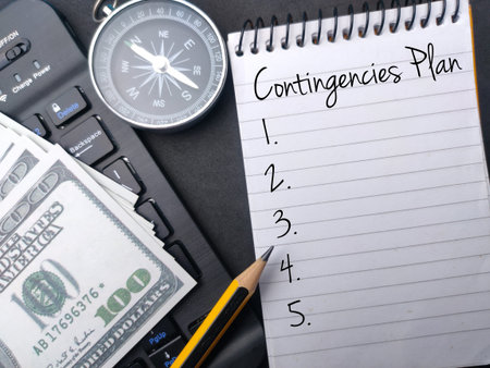 Notebook and pencil with the word Contingencies Plan. Business concept.