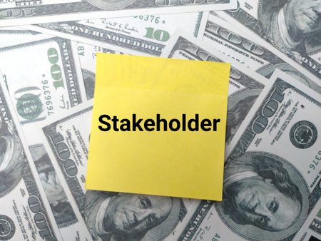 Sticky notes with the word Stakeholder on a banknotes background.