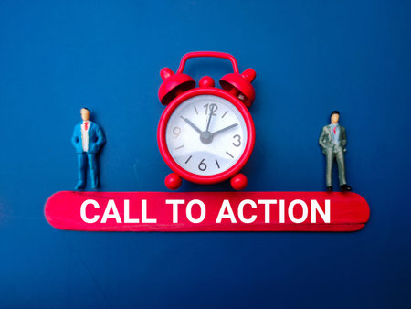 Miniature people and alarm clock with the word call to action. Business concept.